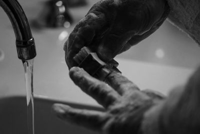 Cropped image of man washing hands