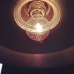 Low angle view of lit light bulb