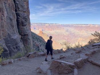 Full length of man standing on mountain against sky