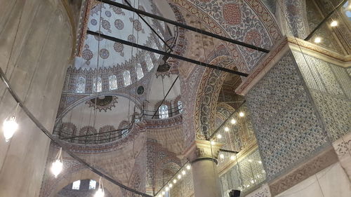 Low angle view of illuminated ceiling in temple