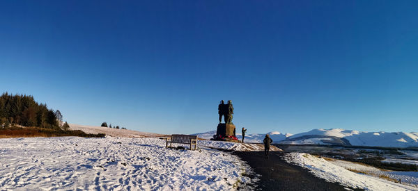 Snow covered mountain against clear blue sky