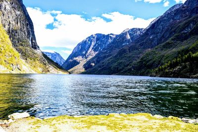 Scenic view of lake and mountains against sky