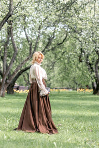 Rear view of woman standing on field