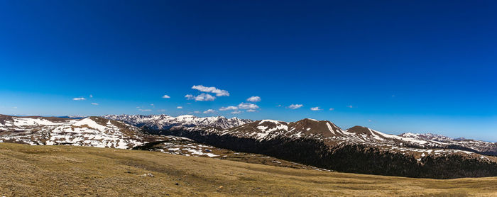 Scenic view of mountains against blue sky