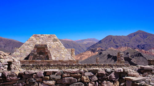 Scenic view of rocky mountains against clear blue sky