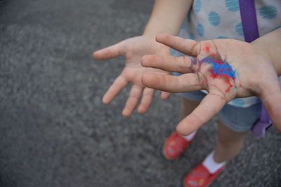 Low section of girl holding powder paint