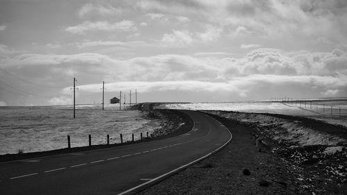 Road by sea against sky