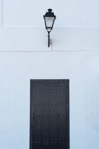 Lamp post against built structure