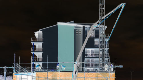 Low angle view of construction site against sky at night