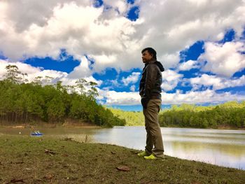 Full length of man standing on landscape against sky