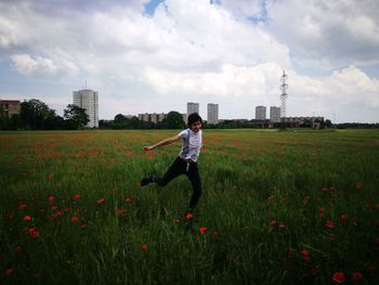 Man standing on field against sky