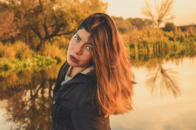 Portrait of young woman standing on field