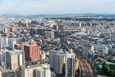 High angle view of modern buildings in city against sky