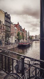 Bridge over river against buildings in city