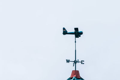 Low angle view of telephone pole against clear sky