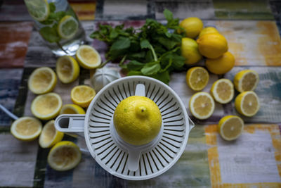 Top view of preparation of fresh juices press on fresh lemon and lime. lemon squeezer machine.