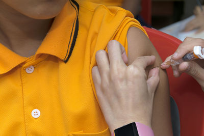 Close-up of woman holding yellow hands