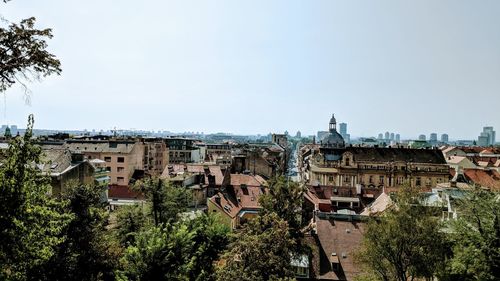 Buildings in city against clear sky