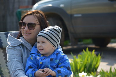 Portrait of smiling mother and daughter outdoors