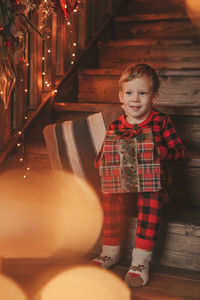 Smile small child being active having fun waiting for miracle santa open presents.