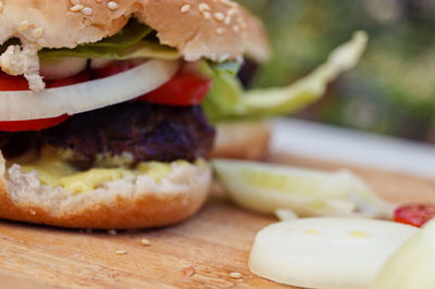 Cropped image of burger on cutting board