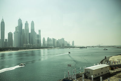 Panoramic view of sea and buildings against sky