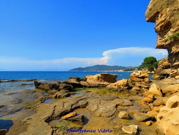 Scenic view of sea against blue sky