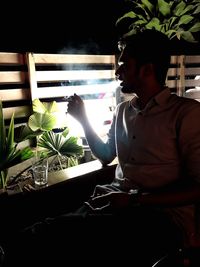 Man looking at potted plant in restaurant