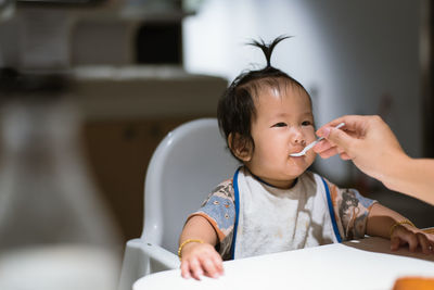 Close-up of baby girl eating