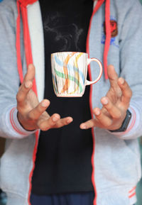 A man holding a coffee mug 