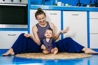 Healthy snacks for babies and toddlers. happy loving family. candid young mother feeding her cute