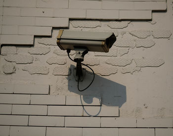 Close-up of cctv or  electric lamp on wall