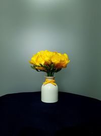 Close-up of yellow flower vase on table