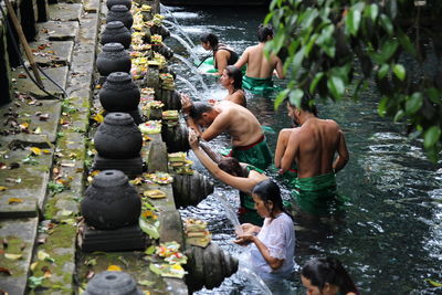 People waiting for bath in fountain at temple