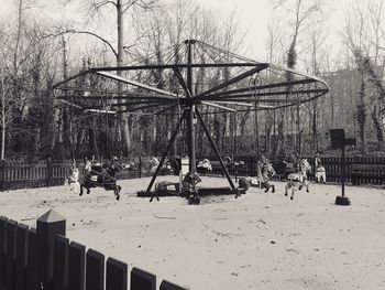 Bare trees on snow covered field