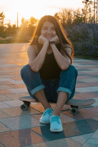 Portrait of smiling young woman sitting outdoors