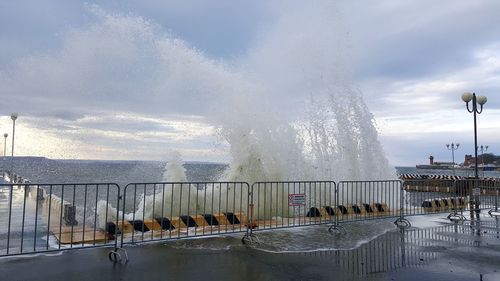 Water splashing on fountain against sky