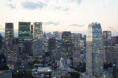 Aerial view of buildings in city against sky