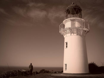 Lighthouse against sky at sunset