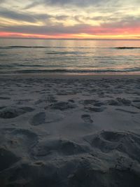 Scenic view of beach against sky during sunset