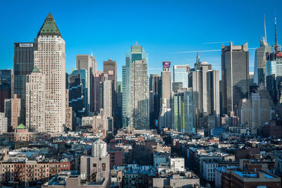 Modern buildings in city against clear sky