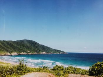 Scenic view of beach against blue sky