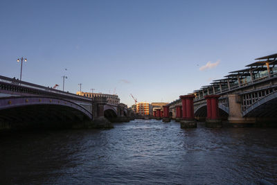 Bridge over river against clear sky