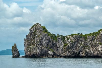 Rock formations by sea against sky