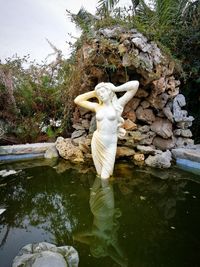 Statue of man in water