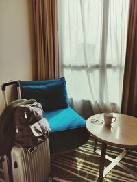 Table and chairs on bed by window at home