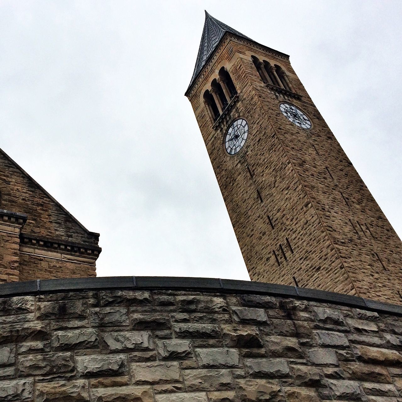 architecture, building exterior, built structure, low angle view, tower, clock tower, history, sky, brick wall, clear sky, old, tall - high, window, day, outdoors, stone wall, no people, clock, high section, tall