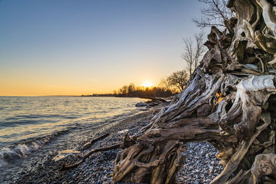 Scenic view of frozen sea against sky during sunset