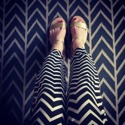 Low section of woman standing on tiled floor