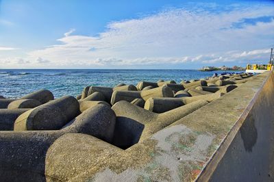 Panoramic view of rocks on beach against sky